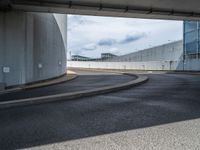 a car is driving on the highway through an underground parking garage area in a city