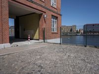 this is a brick building and fenced in area for the gate to be opened
