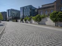 the stone path has been built along the side of the street and is lined with buildings