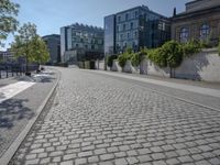 the stone path has been built along the side of the street and is lined with buildings
