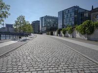 the stone path has been built along the side of the street and is lined with buildings