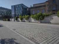 the stone path has been built along the side of the street and is lined with buildings