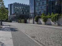 the stone path has been built along the side of the street and is lined with buildings