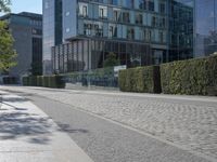 the stone path has been built along the side of the street and is lined with buildings