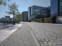 the stone path has been built along the side of the street and is lined with buildings