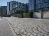 the stone path has been built along the side of the street and is lined with buildings