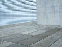 a brick patio area features a white fence with a white wall behind it and lots of light wood trimming on the side of the building