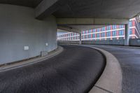 a car is driving on the highway through an underground parking garage area in a city