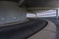 a car is driving on the highway through an underground parking garage area in a city