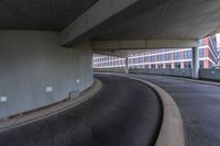 a car is driving on the highway through an underground parking garage area in a city