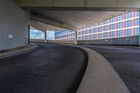 a car is driving on the highway through an underground parking garage area in a city