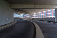 a car is driving on the highway through an underground parking garage area in a city