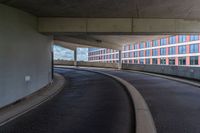 a car is driving on the highway through an underground parking garage area in a city