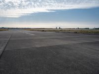 an airplane taking off from an airport tarmac with an arch in the distance and blue skies in the background