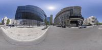 a 360 - view of the intersection of a city street and an office building in the distance