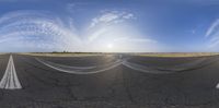 there is a runway and a view of a bright sky taken through the lens,