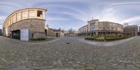 a fish eye view of buildings at the side of the street and from which you can see the building