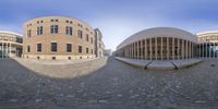 a wide angle view of a building next to another building has multiple levels and angles