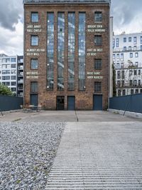 a brick building that is on the ground with signs attached to it on it's side