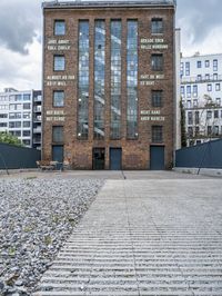 a brick building that is on the ground with signs attached to it on it's side