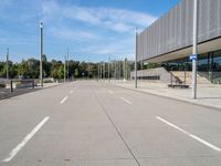 the empty street is in between the buildings at the bus stop area on a clear day