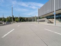 the empty street is in between the buildings at the bus stop area on a clear day