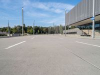 the empty street is in between the buildings at the bus stop area on a clear day