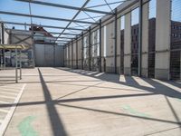 inside of an industrial building that has white paint on the floor and white wall with green lines