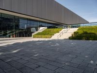 the outside of a building and stairs with a bench with steps up to it on the ground