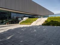 the outside of a building and stairs with a bench with steps up to it on the ground