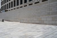 an empty brick walkway in front of the capitol for change sign outside the building on a sunny day