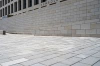 an empty brick walkway in front of the capitol for change sign outside the building on a sunny day