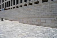 an empty brick walkway in front of the capitol for change sign outside the building on a sunny day