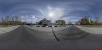 a view of a street through a fisheye lens on a skateboard ramp while parked