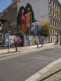 a mural of a person is on the wall of an old building with graffiti in it