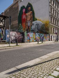 a mural of a person is on the wall of an old building with graffiti in it