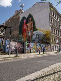 a mural of a person is on the wall of an old building with graffiti in it