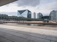 a bridge crosses over a river in the middle of buildings on either side of it