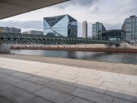 a bridge crosses over a river in the middle of buildings on either side of it