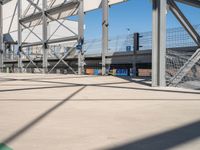 a young boy riding a skate board on a skate ramp in a large concrete structure