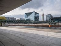 a train on the tracks near the buildings of a business district with many vehicles and people