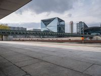 a train on the tracks near the buildings of a business district with many vehicles and people