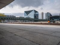 a train on the tracks near the buildings of a business district with many vehicles and people