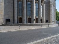 an entrance of a building with large columns and doors that spell out the word voltege