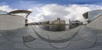 a fisheye lens photograph showing an architectural view in the sky and on the floor below