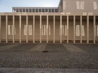 the shadow of poles cast by the sun on the outside wall of the building, casting light onto the floor