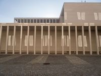 the shadow of poles cast by the sun on the outside wall of the building, casting light onto the floor