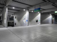 parking garage floor with silver tiles and circular holes at the entrance to the building and signs