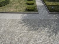 an aerial view of the courtyard from above in a city park with trees, shrubs and grass