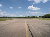 an airport has a broken section of the runway, with yellow lines drawn across it